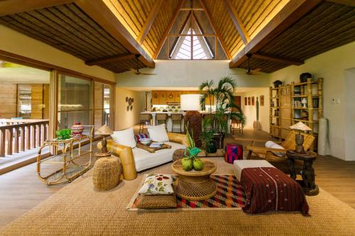 a living room with a couch and a table at Bahay Artisano in El Nido