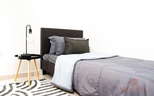 a bedroom with a bed and a side table at Nid de Rêve Accomodation in Sandton