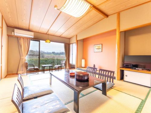 a living room with a table and chairs at Tabist Healthy Pal Akagi in Shibukawa