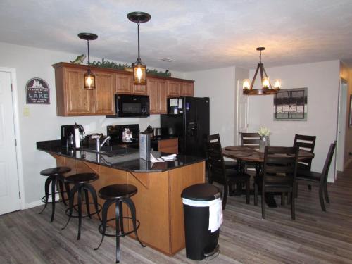 a kitchen and dining room with a counter and a table at Lakefront Condo A-1 with Large Balcony in Hollister