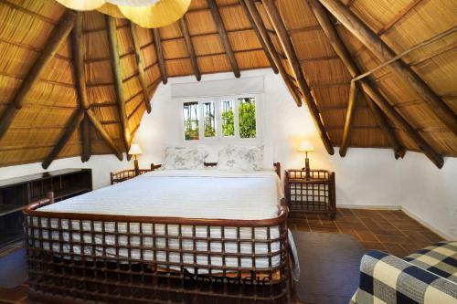 a bedroom with a large bed in a room with wooden ceilings at Casa en Punta del Este in Punta del Este