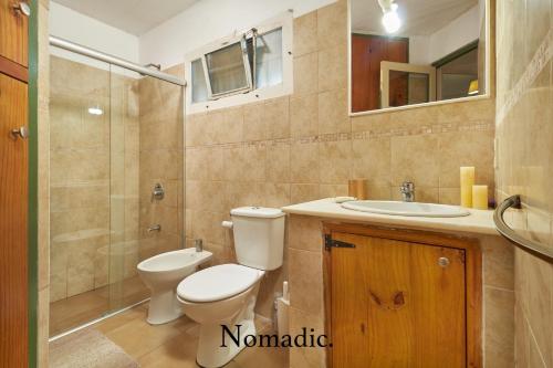 a bathroom with a toilet and a sink and a shower at Casa en Punta del Este in Punta del Este