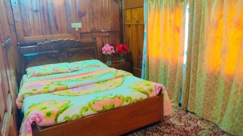 a bedroom with a bed with a wooden head board at Houseboat young wild Rose in Srinagar