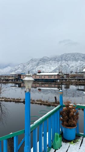 a train on a bridge over a body of water at Houseboat young wild Rose in Srinagar