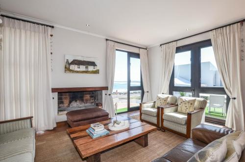 a living room with a couch and a fireplace at NetReg in Yzerfontein