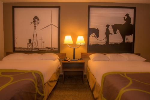 a hotel room with two beds and two lamps at Super 8 by Wyndham Oklahoma Airport Fairgrounds West in Oklahoma City