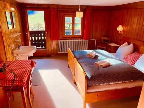 a bedroom with a large bed with red walls at Hüttenzauber Ferienwohnung in Vandans