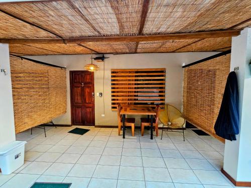 a dining room with a wooden table and chairs at Santa Toro in Santa Teresa Beach