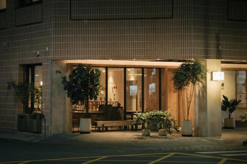 a building with a bench in front of a building at Norden Ruder Hostel Taitung Branch 2 in Taitung City