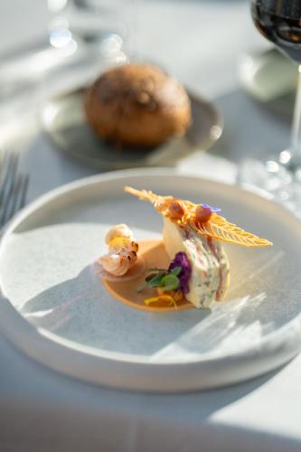 a white plate with food on a table at Hotel Winselerhof by Flow in Landgraaf