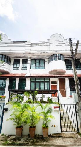 a building with potted plants in front of it at Amata Lanna Chiang Mai, One Member of the Secret Retreats in Chiang Mai