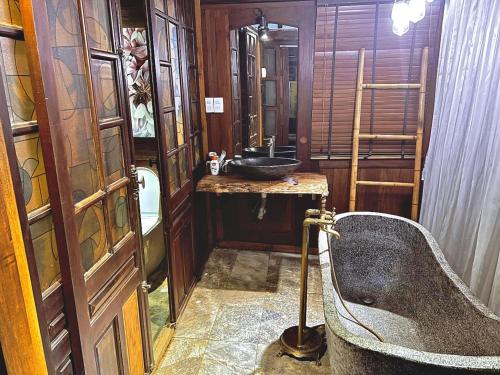 a bathroom with a sink and a bath tub at Zen House Hoi An - Wooden House in Hoi An