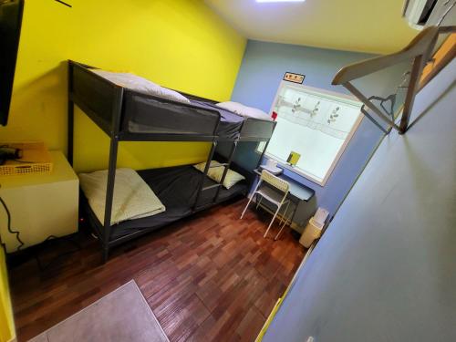 a room with two bunk beds and a desk at 24 Guesthouse Sinchon Avenue in Seoul