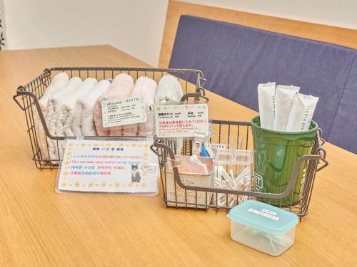 a basket of toilet paper sitting on top of a table at Itosima Guesthouse TOMO in Itoshima