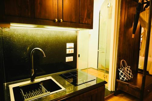 a kitchen with a sink and a faucet at La Belle Maison in Hanoi