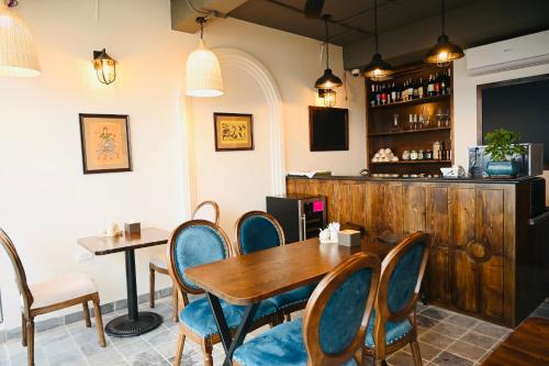 a dining room with a wooden table and chairs at La Belle Maison in Hanoi