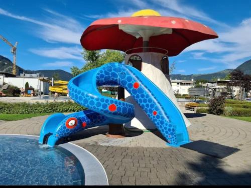 a slide in the shape of an umbrella at Exclusive Tyrolean Chalet near Ski lifts in Apfeldorf