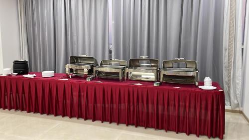 a table with a red table cloth with at Season Inn Hotel in Barka