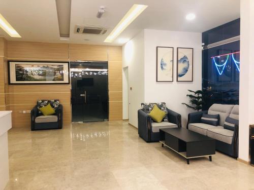 a lobby with two chairs and a couch and a table at Season Inn Hotel in Barka