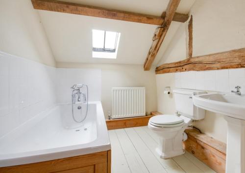 a bathroom with a toilet and a sink at The Cart Lodge in Erpingham