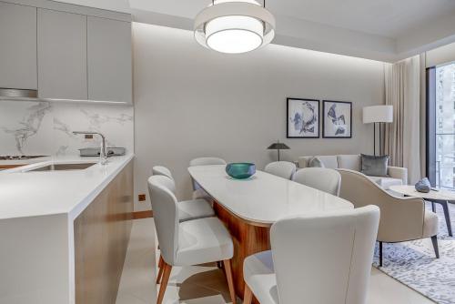 a kitchen and living room with a table and chairs at #37 Luxury - 2BR in The Address Dubai Opera - Downtown in Dubai