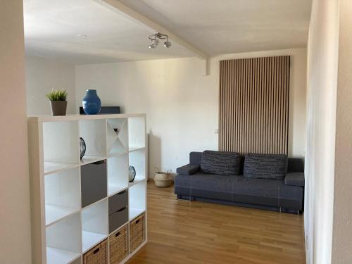 a living room with a couch and a book shelf at Seeblick Faaker See in Drobollach am Faakersee