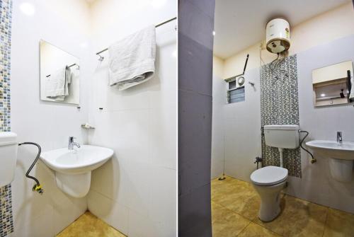 a white bathroom with a toilet and a sink at KOHINOOR INTERNATIONAL LODGE in Kolkata