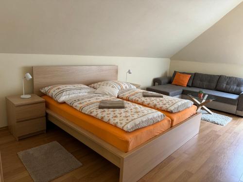 a bedroom with a large bed and a couch at Bystra 150 in Bystrá