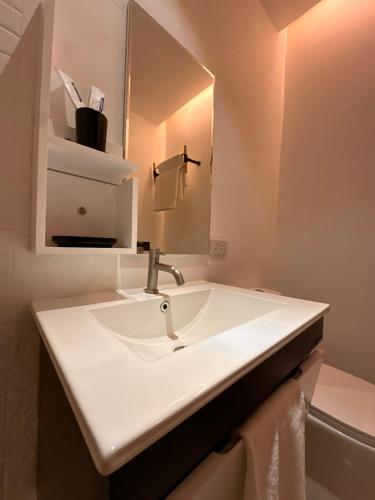 a bathroom with a white sink and a mirror at Urban Boutique Hotel in Boracay