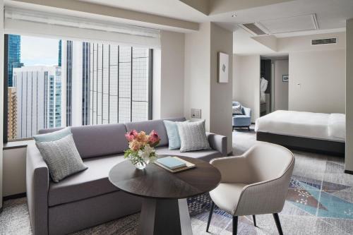 a living room with a couch and a table and a bed at ANA InterContinental Tokyo, an IHG Hotel in Tokyo