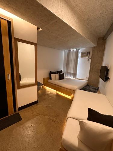 a small room with two beds and a window at Urban Boutique Hotel in Boracay