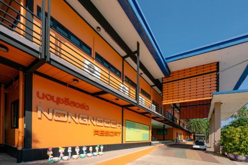 an external view of a building with a university internship sign on it at Nongnooch Garden Pattaya Resort in Ban Nong Chap Tao