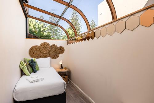 a bedroom with a bed and a window at Swainson on Lady Gowrie in Largs