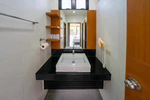 a bathroom with a sink on a black counter at Nongnooch Garden Pattaya Resort in Ban Nong Chap Tao