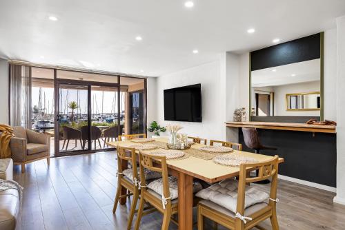 a dining room and living room with a table and chairs at Swainson on Lady Gowrie in Largs