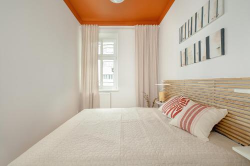 a bedroom with a large white bed and a window at Comfortable & Bright Apartment Rzeszów by Renters in Rzeszów