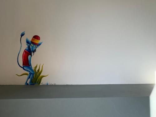 a figurine of a woman with a hat on a shelf at Affittacamere Ca' de Mazapedar in San Lorenzo