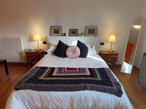 a bedroom with a large bed with a rug on it at Affittacamere Ca' de Mazapedar in San Lorenzo
