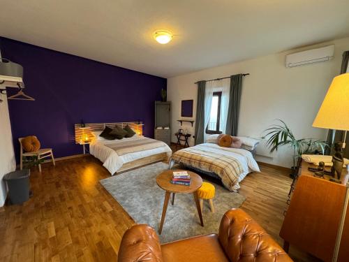 a living room with two beds and a couch at Affittacamere Ca' de Mazapedar in San Lorenzo