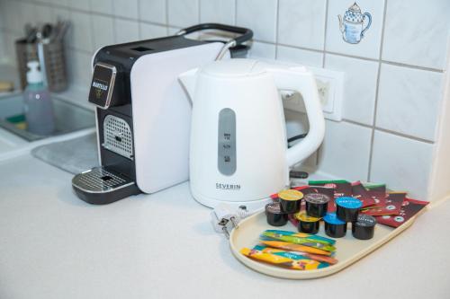 a kitchen counter with a toaster and a plate with toothbrushes at Cozy City Apartments in center K28 in Vienna