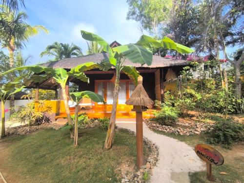 a house with a banana tree in front of it at U Story Resort in Siquijor