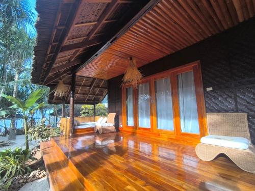 a living room of a house with a wooden floor at U Story Resort in Siquijor
