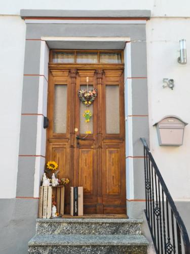 a wooden door on a building with stairs at Haus Kurtrier in Merl