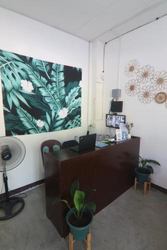 an office with a desk with a laptop on it at Aloha Hostel Siargao in General Luna
