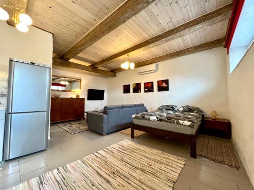 a living room with a couch and a refrigerator at Valgeranna Apartment in Pärnu