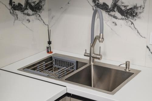 a kitchen with a sink and a faucet at Апартаменты на Гагарина in Almaty