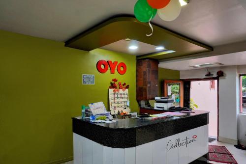 a restaurant with a counter with a balloon on the wall at Collection O New Hotel River Side in Bilāspur