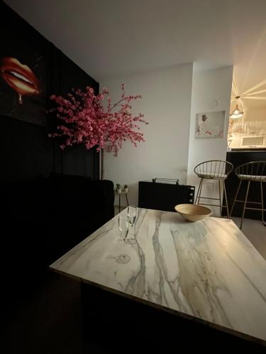 a table with two wine glasses on top of it at Tea Modern Apartament in Pristina