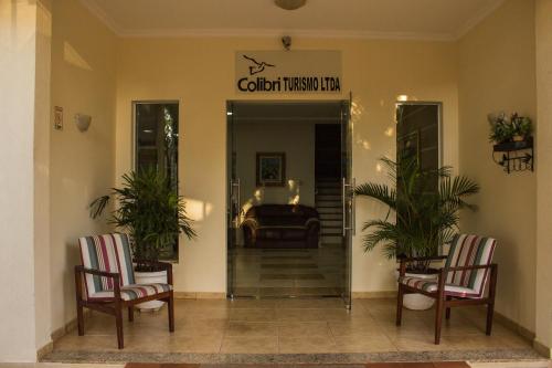 a lobby with two chairs and a sign that reads colonial museum at Pousada Cataratas in Foz do Iguaçu