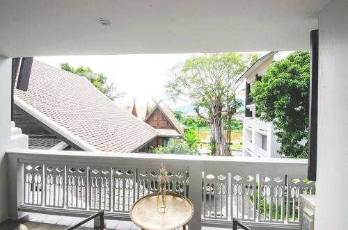 a view from the balcony of a house with a table at Buri Sriping Riverside Resort & Spa in Chiang Mai